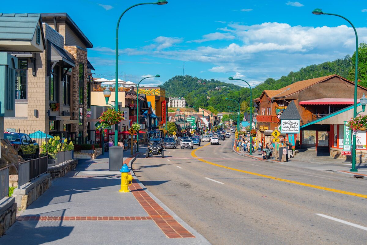 Gatlinburg's main street lined with shops, with mountains behind