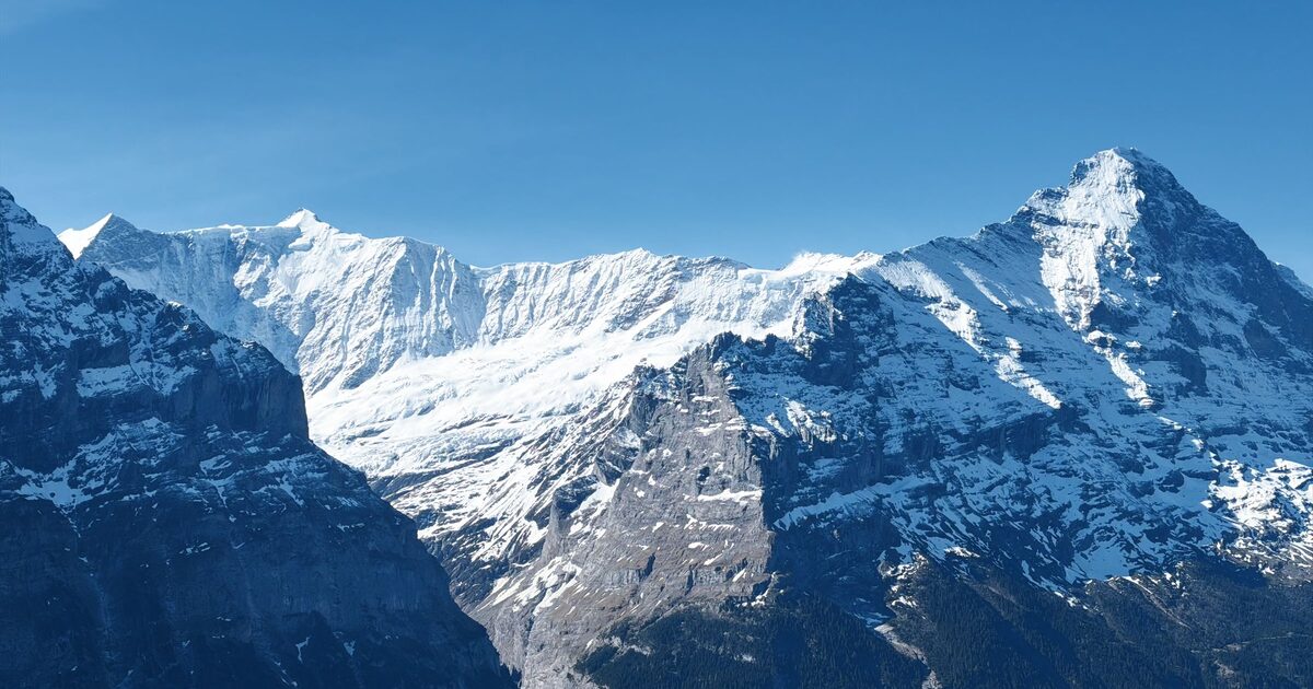 The Eiger and the Fiescher ridge in snow under a clear blue sky above Grindelwald