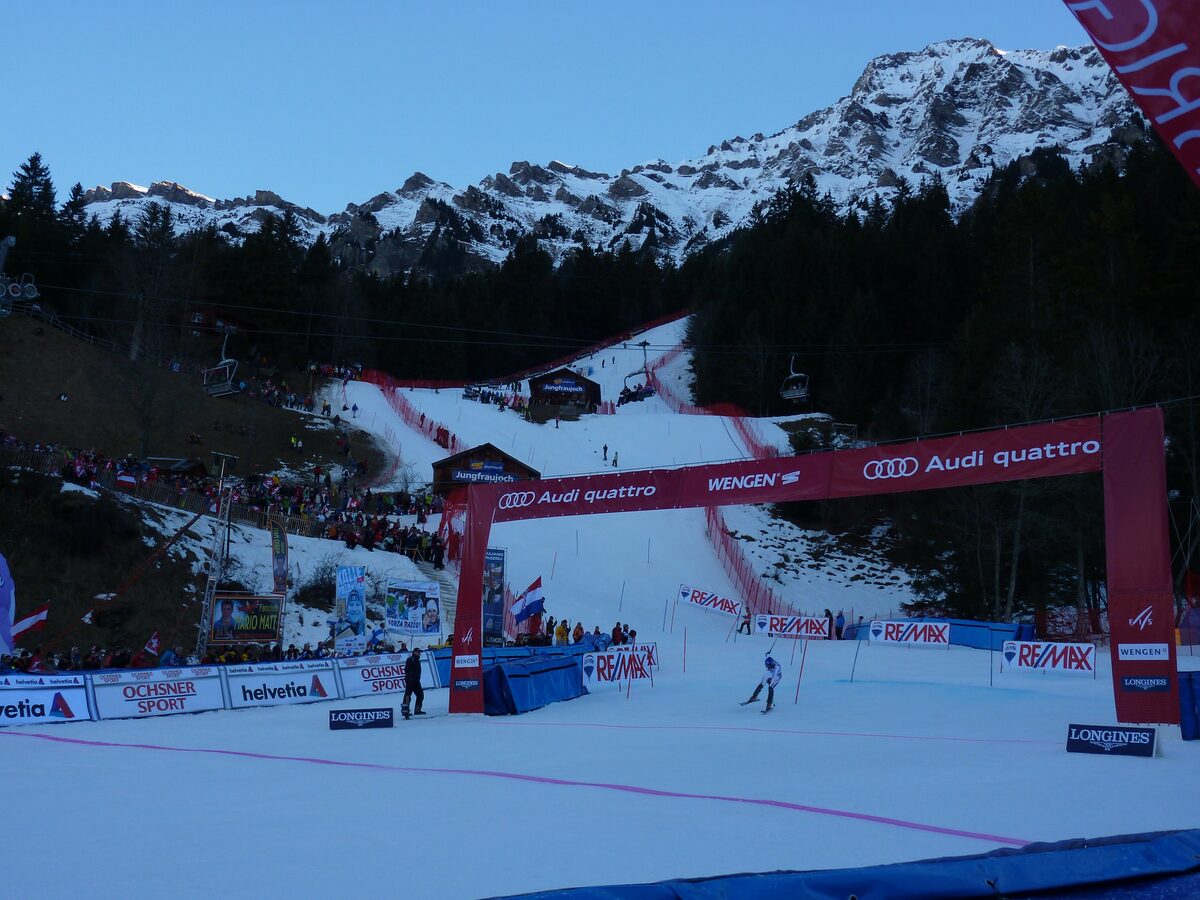 The slalom course of the Lauberhorn races in Wengen with a red start arch and spectators