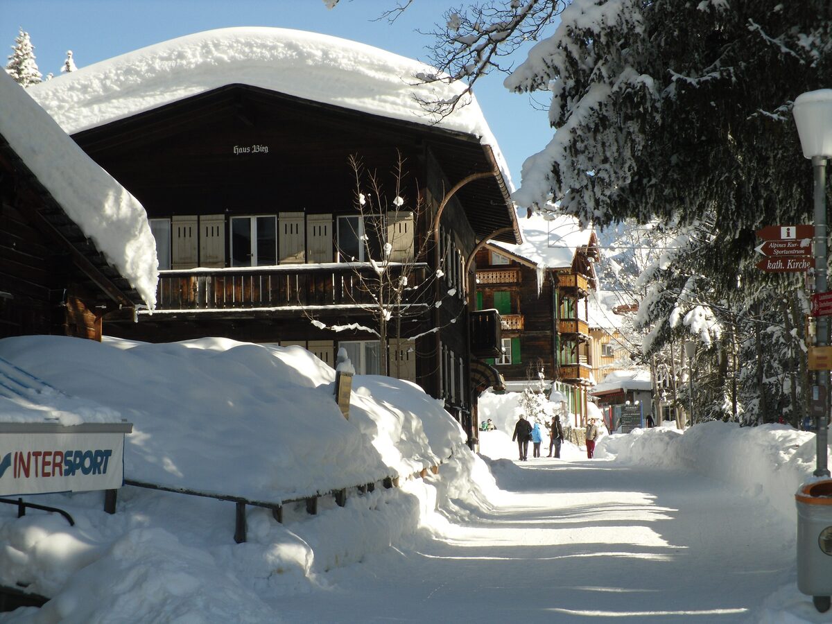 A snow-covered chalet and a car-free lane in Mürren in winter