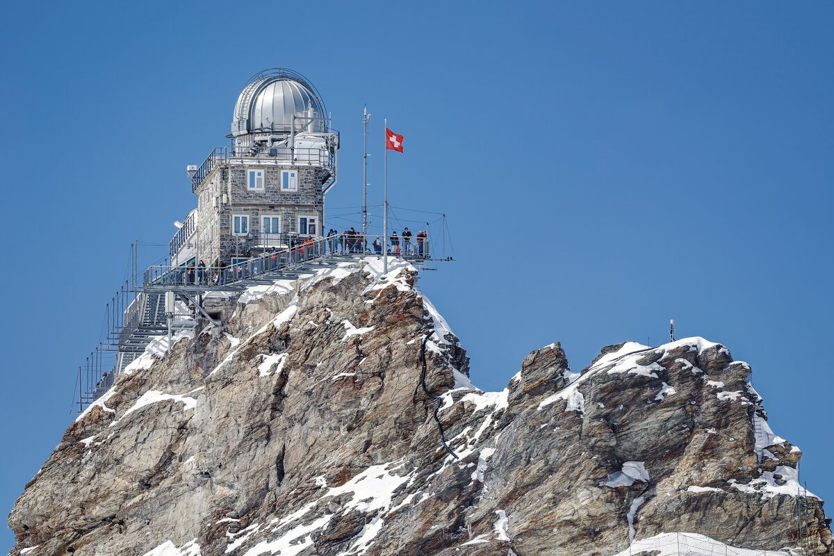 The Sphinx Observatory on its rock summit at the Jungfraujoch under a blue sky