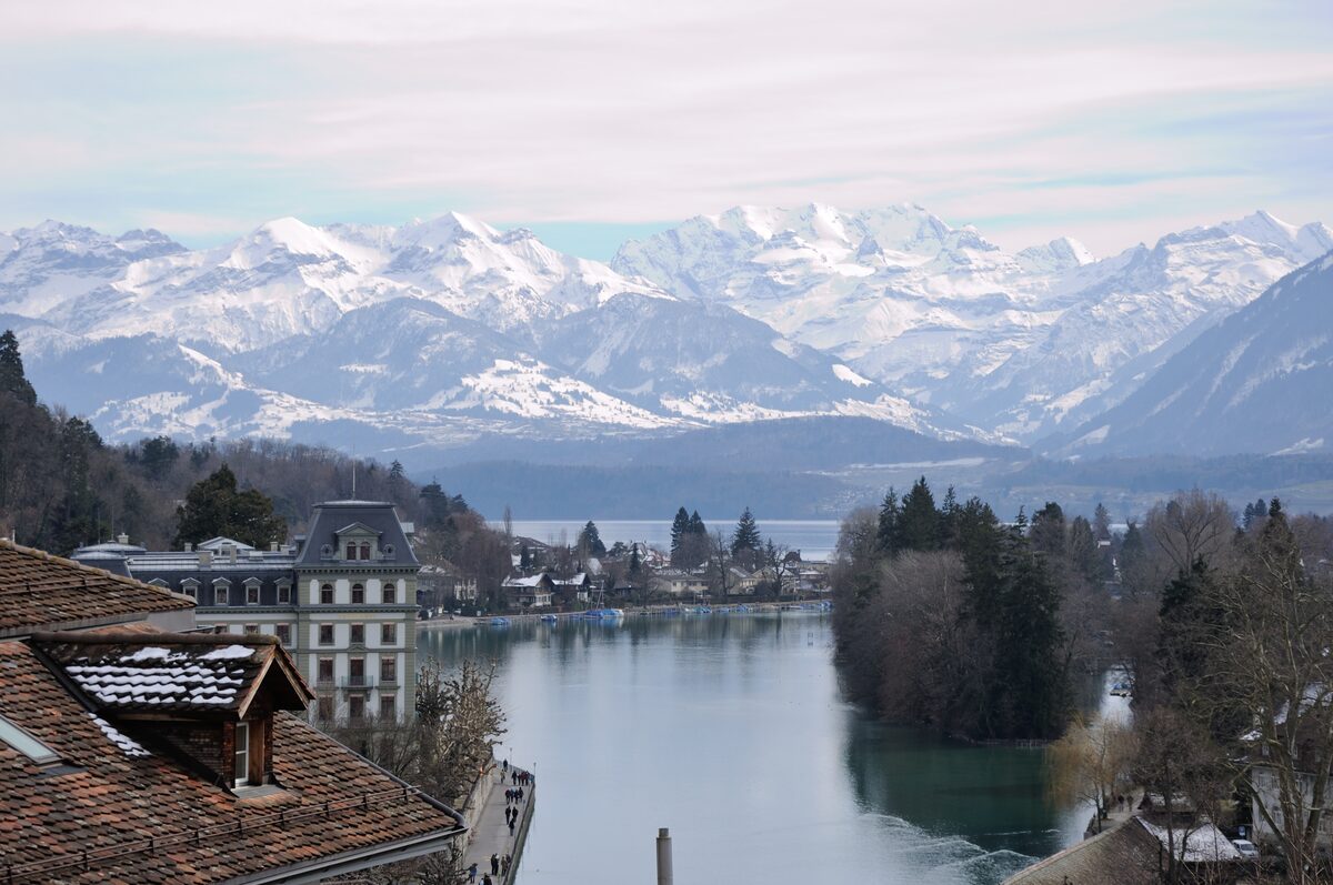 Thun's lakeside with snow-covered Alps behind the town
