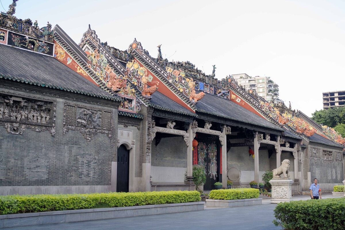 The grey brick walls and ridge roofs covered in colorful ceramic figures at the Chen Clan Ancestral Hall