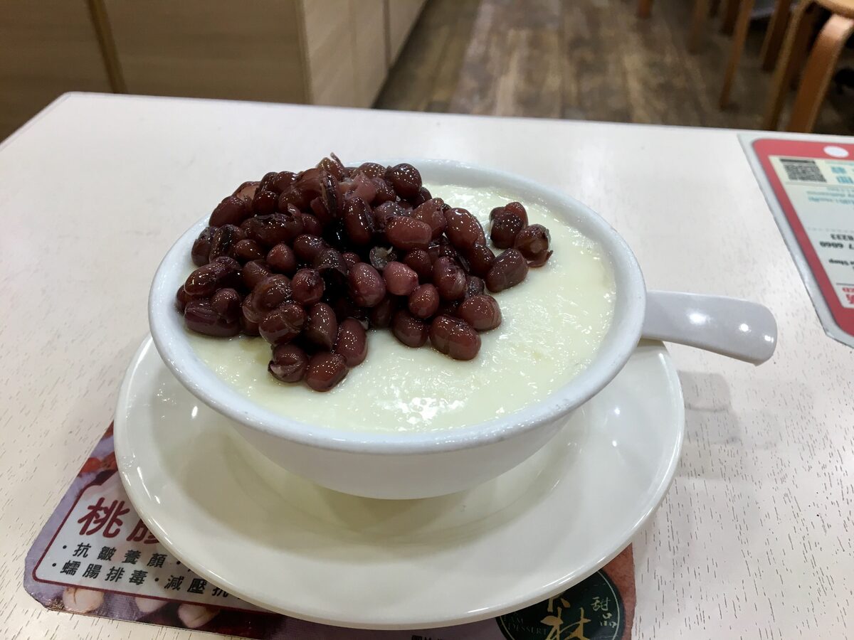 A bowl of double-skin milk pudding topped with sweet red beans