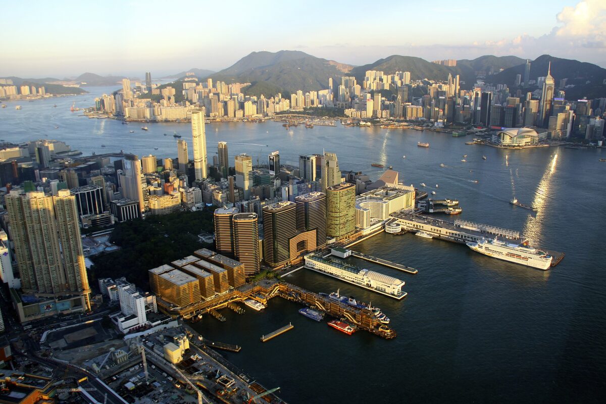 Aerial view of Victoria Harbour with the Hong Kong skyline and the hills behind it
