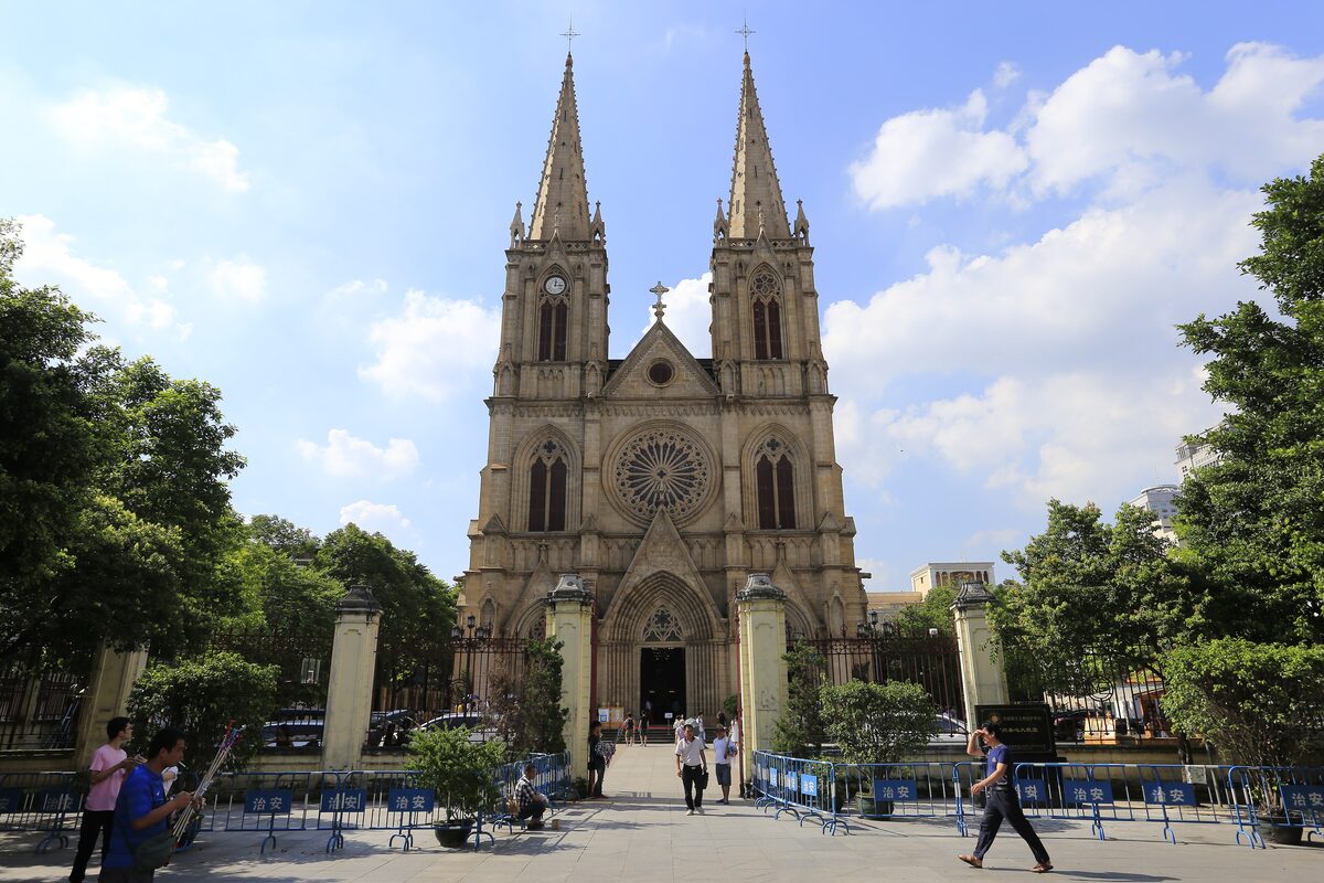 The twin granite spires and rose window of Sacred Heart Cathedral seen from the square in front