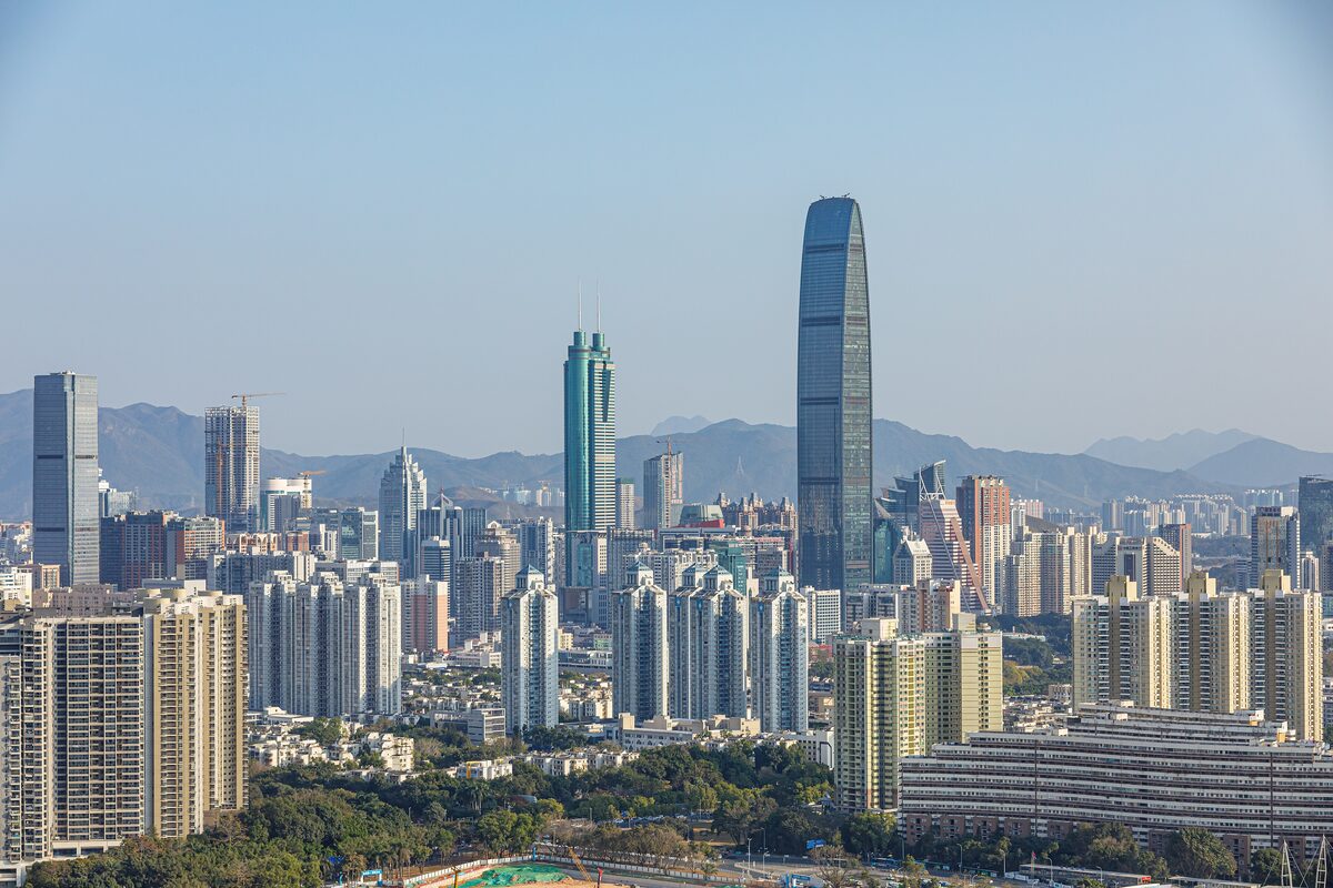 High-rise towers of central Shenzhen with the tall Kingkey 100 tower and hills in the distance
