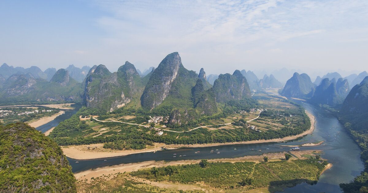 Limestone karst peaks and a bend of the Li River seen from a viewpoint near Yangshuo in Guangxi