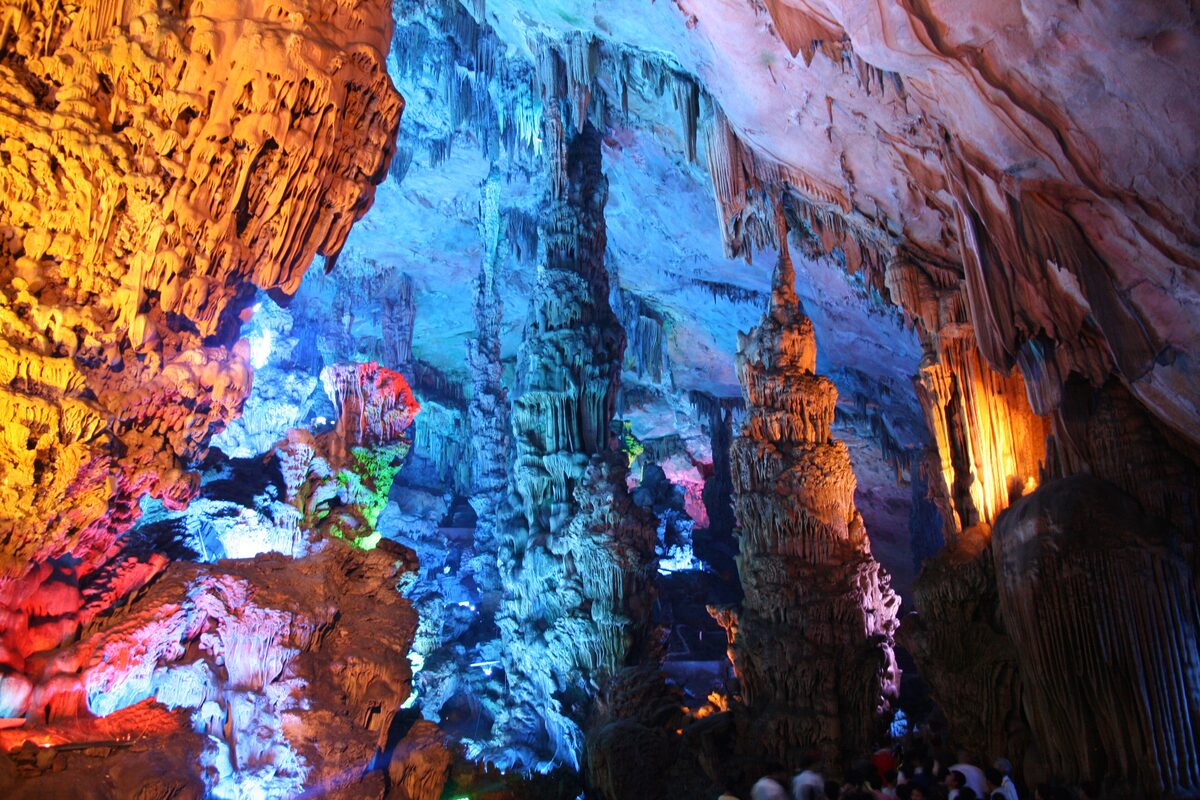 Colored lights on stalactites and stalagmites inside Reed Flute Cave in Guilin