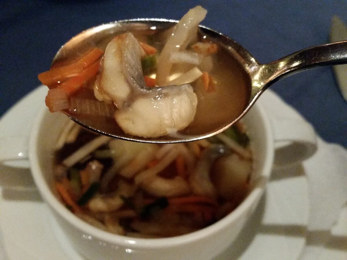 A spoonful of Hamburg eel soup lifted from a cup