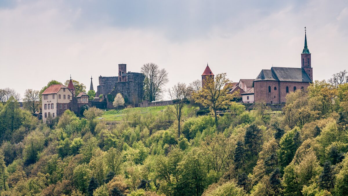 The fortified hill village of Dilsberg, with its castle ruin and church tower rising out of the forest