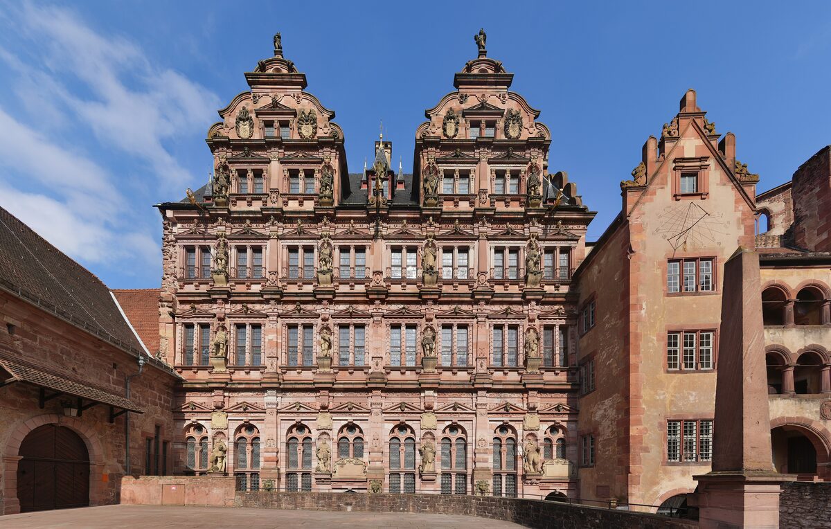 The ornate Renaissance facade of the Friedrichsbau at Heidelberg Castle, with carved statues in red sandstone