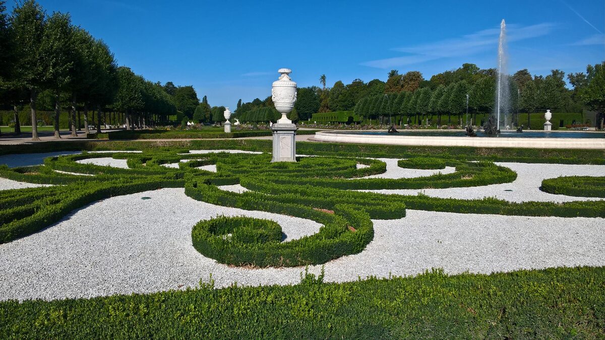 Clipped box-hedge scrollwork and a fountain jet in the Baroque gardens of Schwetzingen Palace