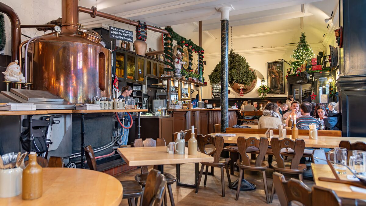 The copper brew kettle and wooden tables inside Vetter's Alt Heidelberger Brauhaus