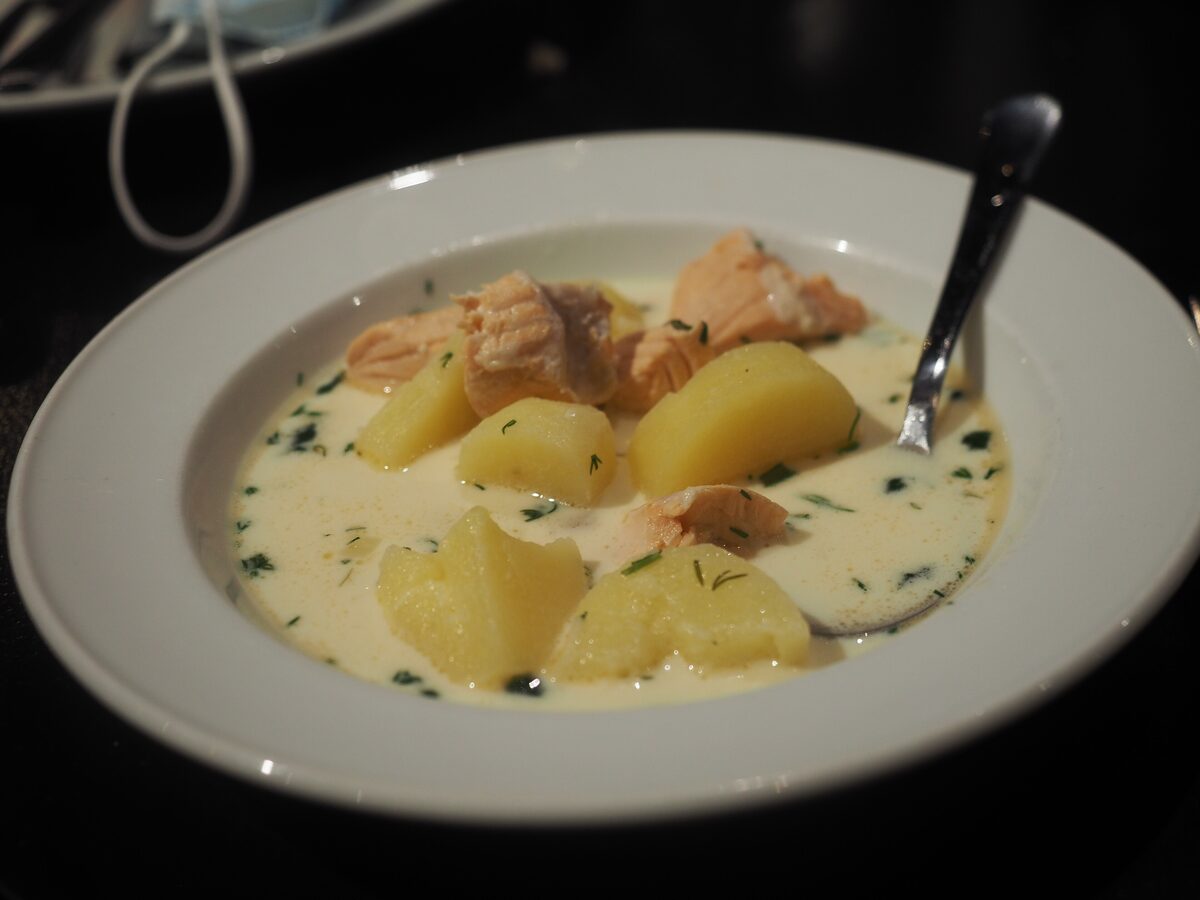 A bowl of creamy Finnish salmon soup with chunks of salmon and potato and chopped dill