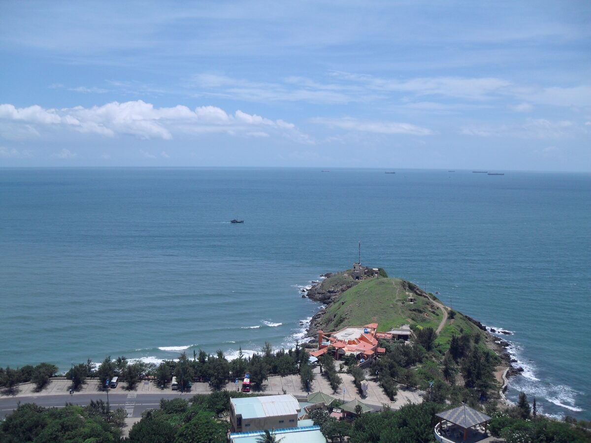 An aerial view of Cape Saint-Jacques, with the headland, the sea and the coast road below