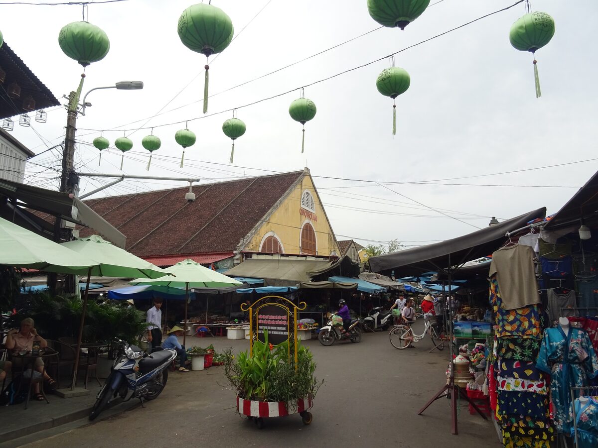 The Hoi An Central Market, a yellow market building with green lanterns over the stalls