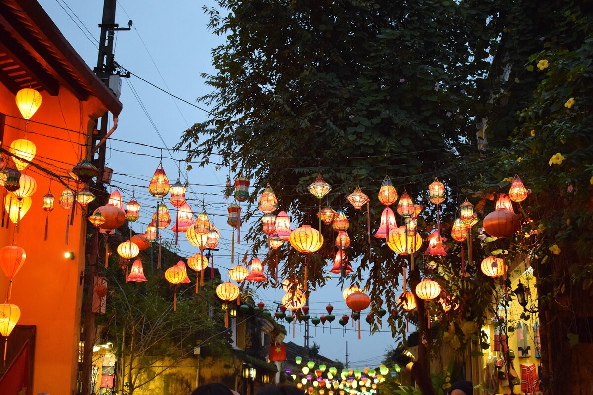 Silk lanterns in red, orange and yellow strung over an Ancient Town street