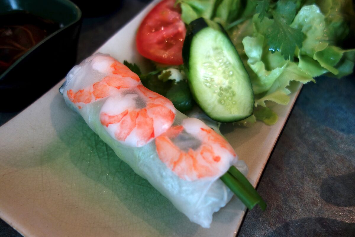 Fresh rice paper rolls with shrimp, cucumber and herbs on a plate