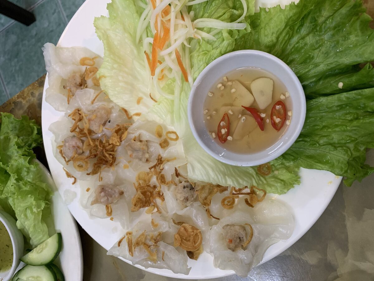Translucent white rose dumplings with a shrimp filling, with lettuce and a dipping sauce