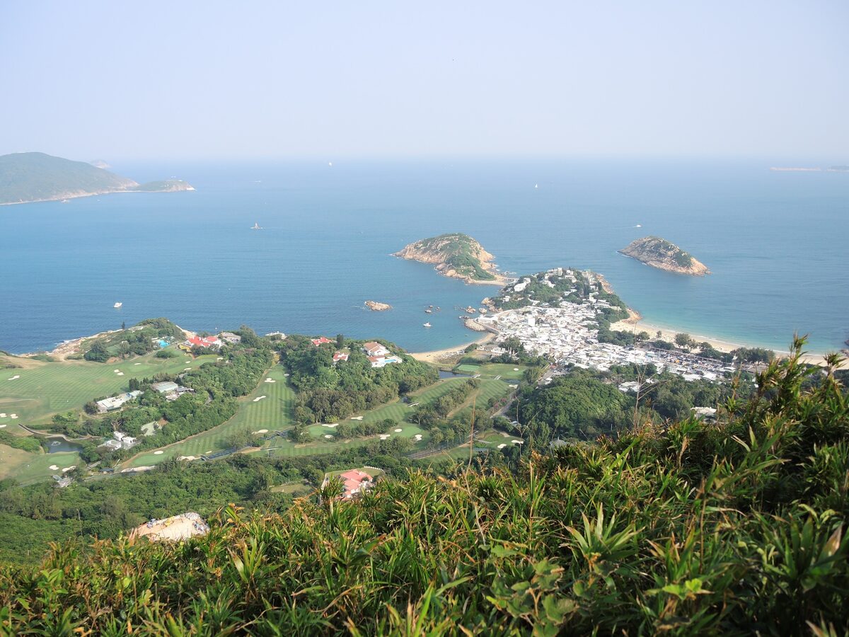 View from the Dragon's Back ridge over Shek O village, its beach, two small rocky islands and a golf course on the headland