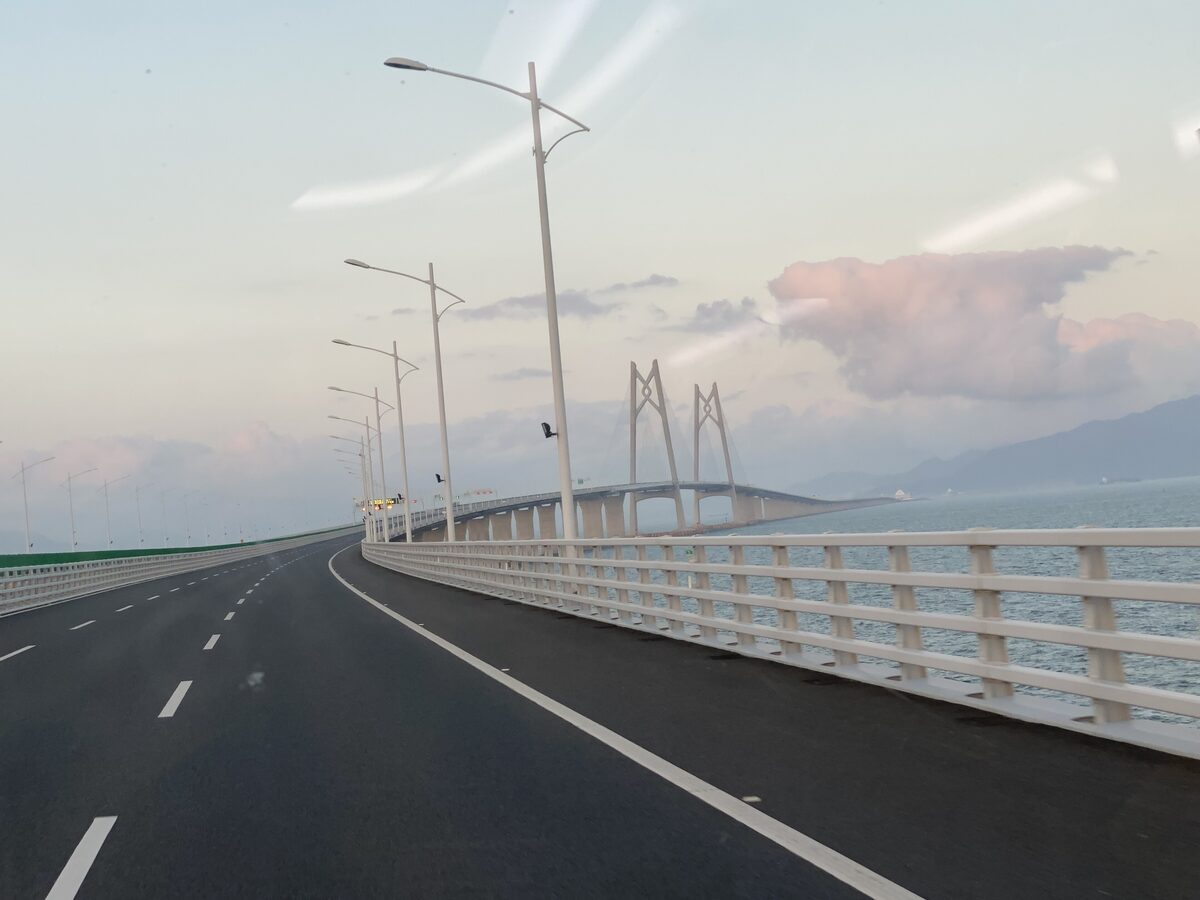 The road deck of the Hong Kong-Zhuhai-Macao Bridge running out over the sea toward cable-stayed towers