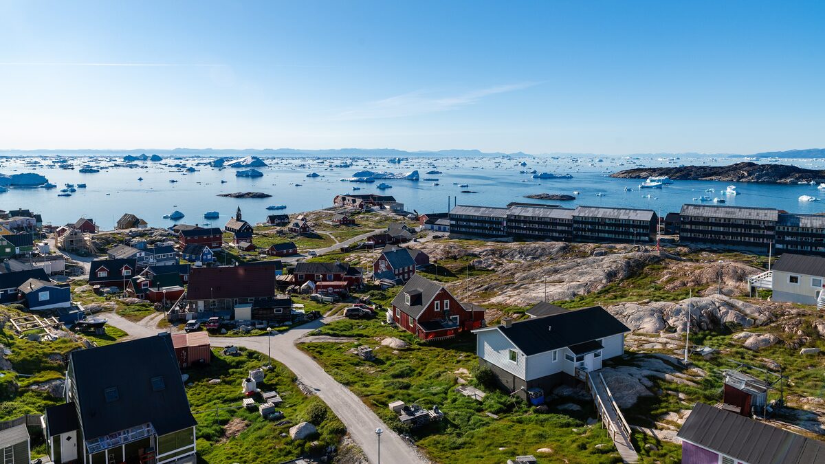 Ilulissat from a rooftop, with colorful houses, the bay and icebergs on the water