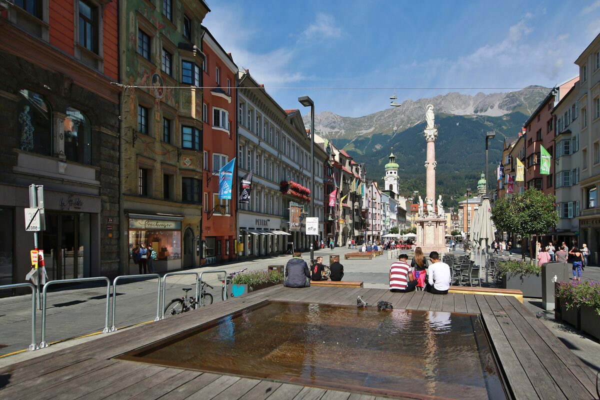 Maria-Theresien-Strasse in Innsbruck with St. Anne's Column and the Nordkette at the end of the street