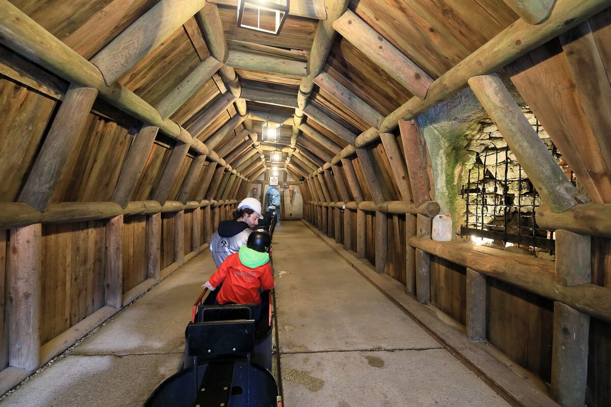 Visitors riding the miners' train into the timbered tunnel of the silver mine at Schwaz