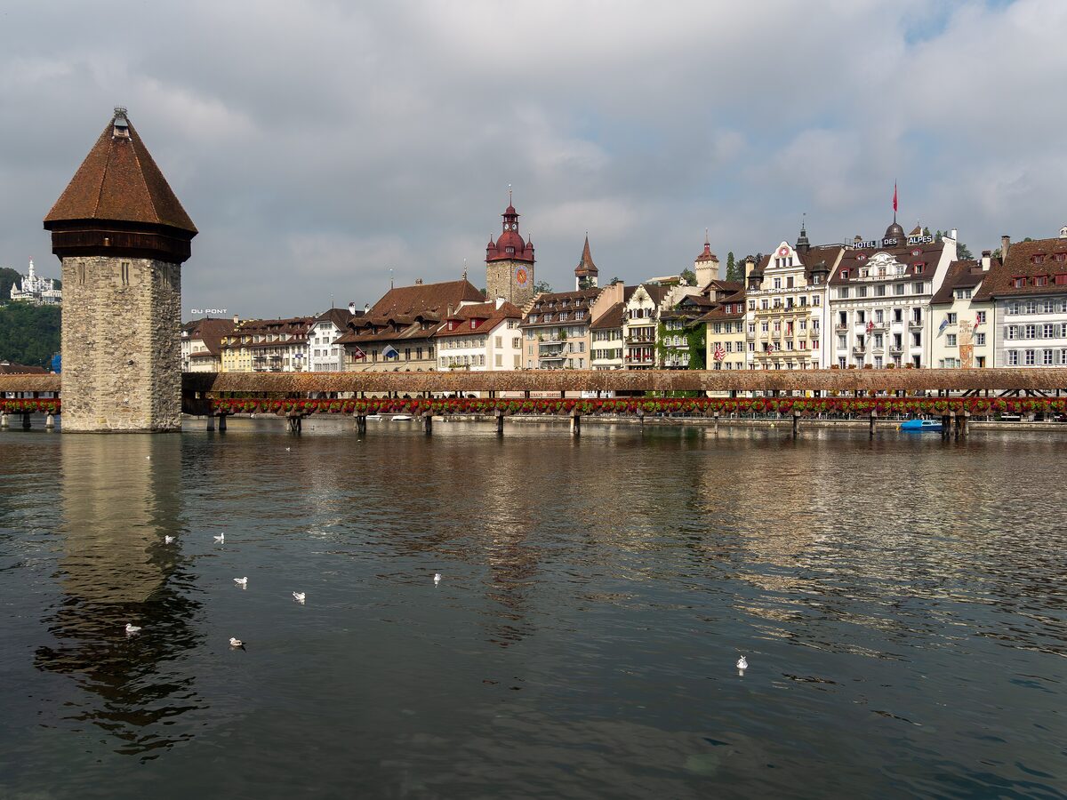 The Chapel Bridge and Water Tower on the Reuss in Lucerne, with the old town on the far bank