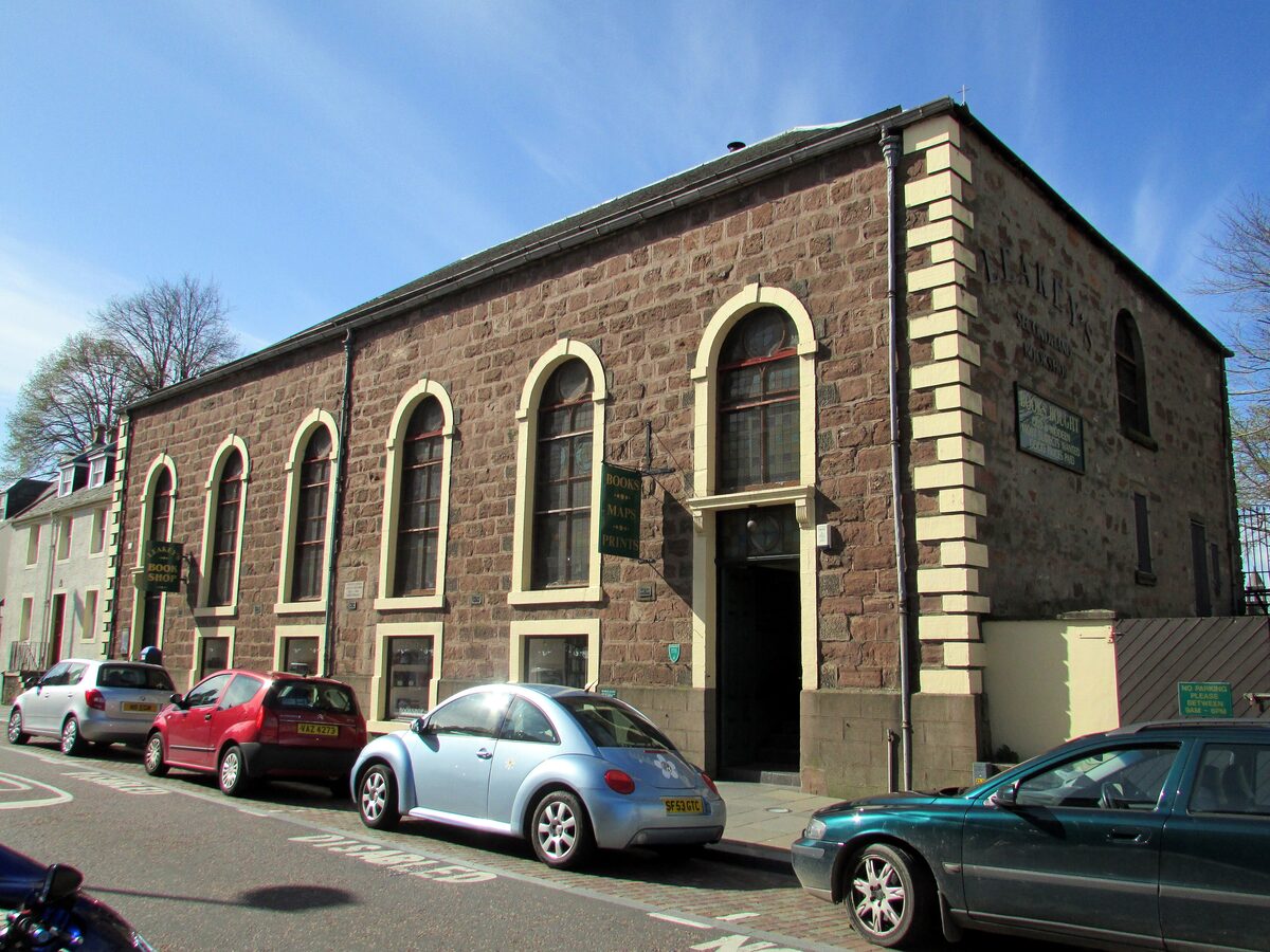 The old Greyfriars Gaelic Church on Church Street in Inverness, a stone building with tall arched windows, now Leakey's Bookshop