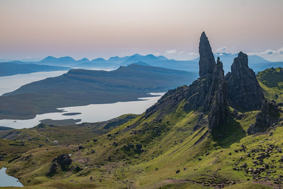 The rock pinnacles of the Old Man of Storr on the Isle of Skye, with lochs and mountains beyond