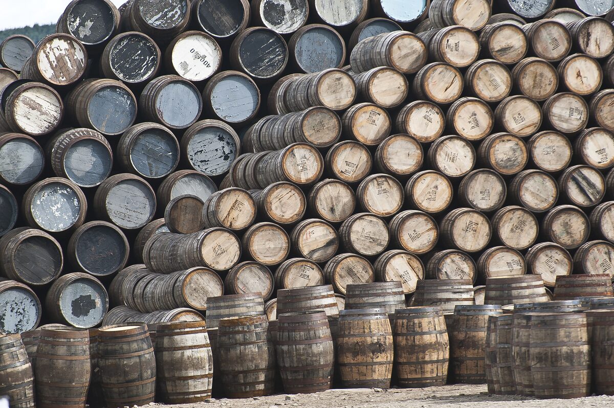 Thousands of wooden whisky casks stacked high at the Speyside Cooperage