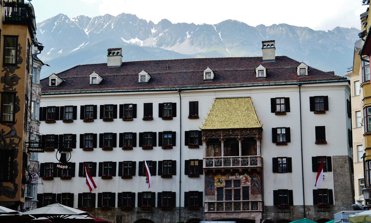 The Golden Roof on its white house front in Innsbruck's old town, with the Nordkette mountains behind