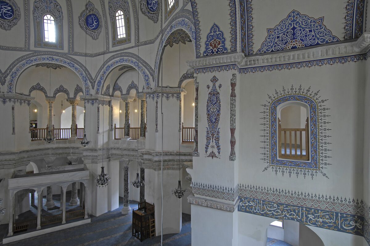 Inside Little Hagia Sophia from the gallery: an octagon of columns and arches with blue Ottoman painted decoration