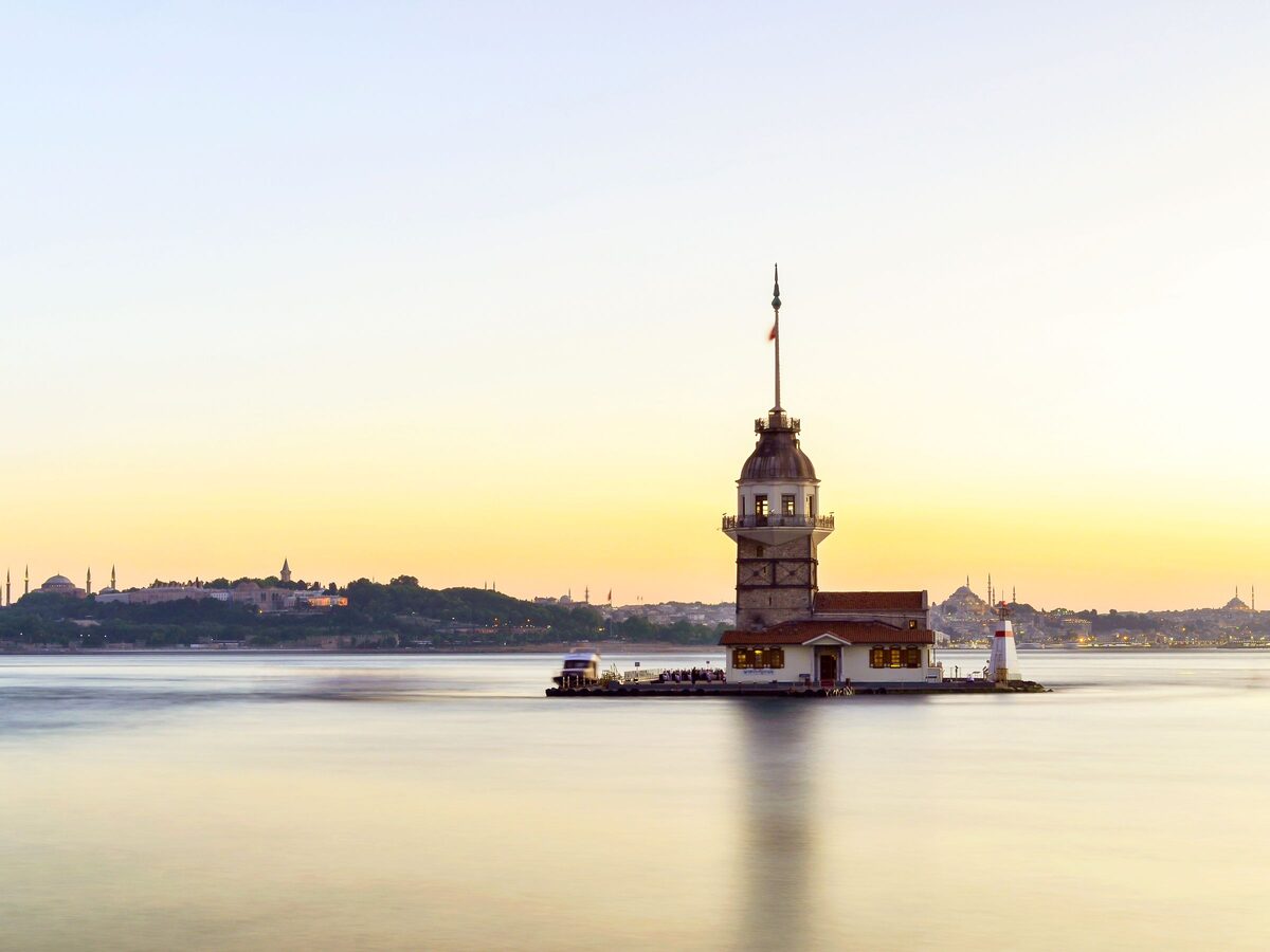 The Maiden's Tower on its islet at sunset, with the skyline of the old city on the horizon