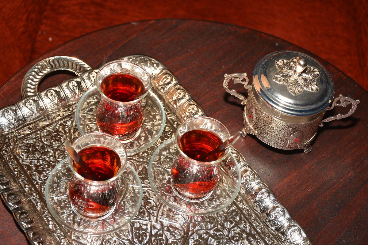 Glasses of Turkish tea on a silver tray with a sugar bowl