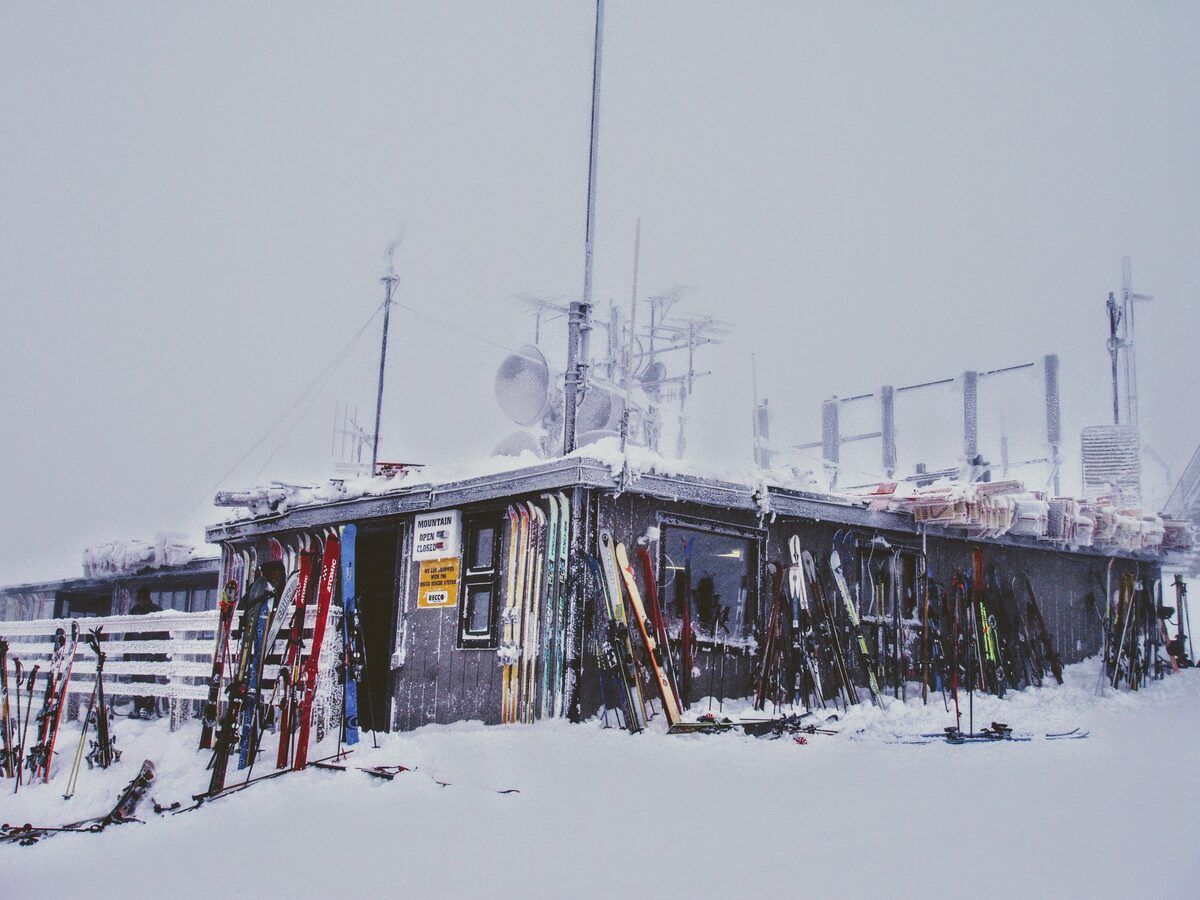 Corbet's Cabin frozen in winter rime at the top of the mountain, with skis stacked along its wall