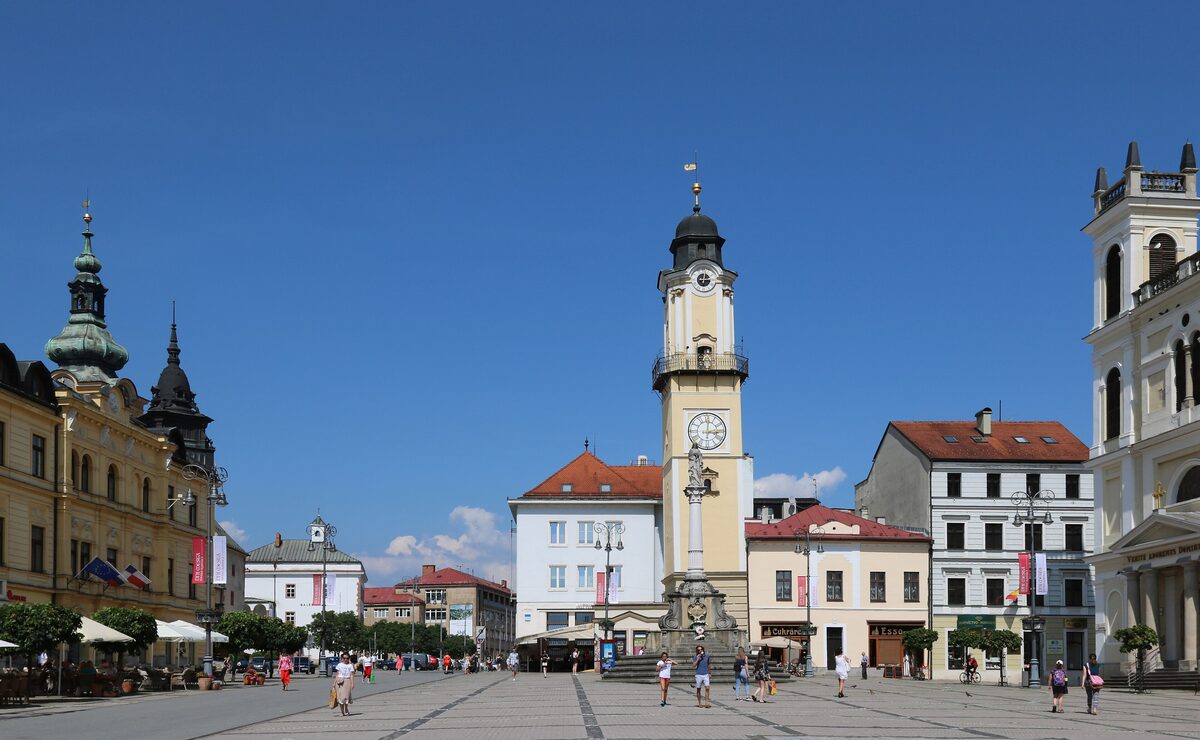 The wide SNP Square in Banská Bystrica with its leaning clock tower and colorful townhouses