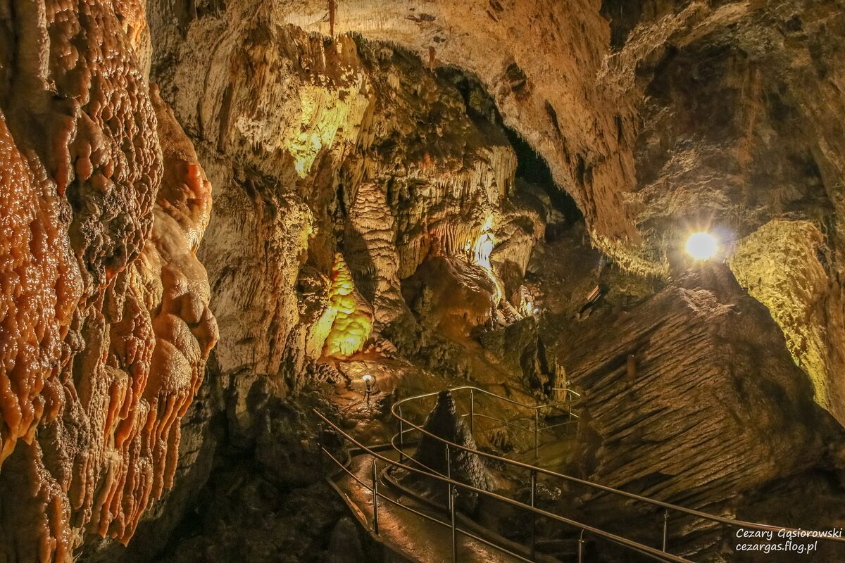 Limestone formations and a metal walkway inside the Demänovská Cave of Liberty