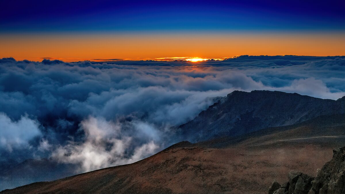 Sunrise above a sea of clouds from Haleakalā on Maui
