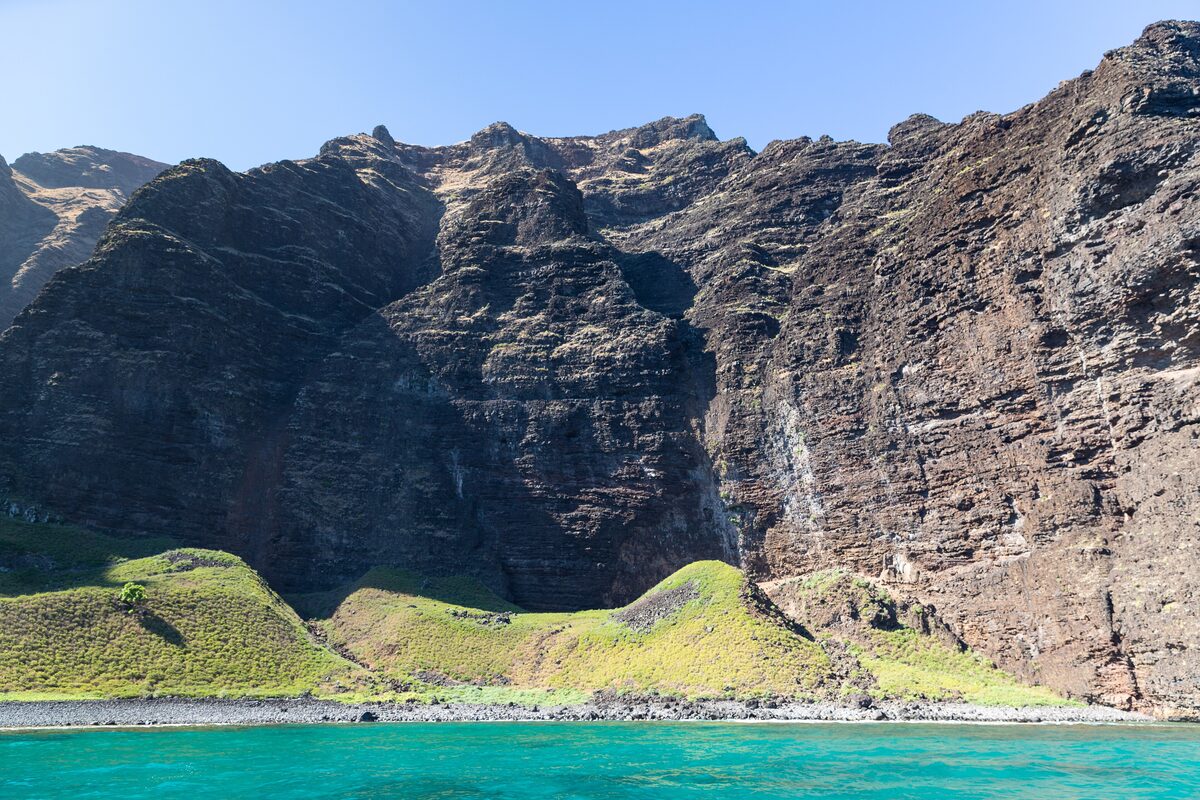 Nā Pali sea cliffs above turquoise water, seen from a boat