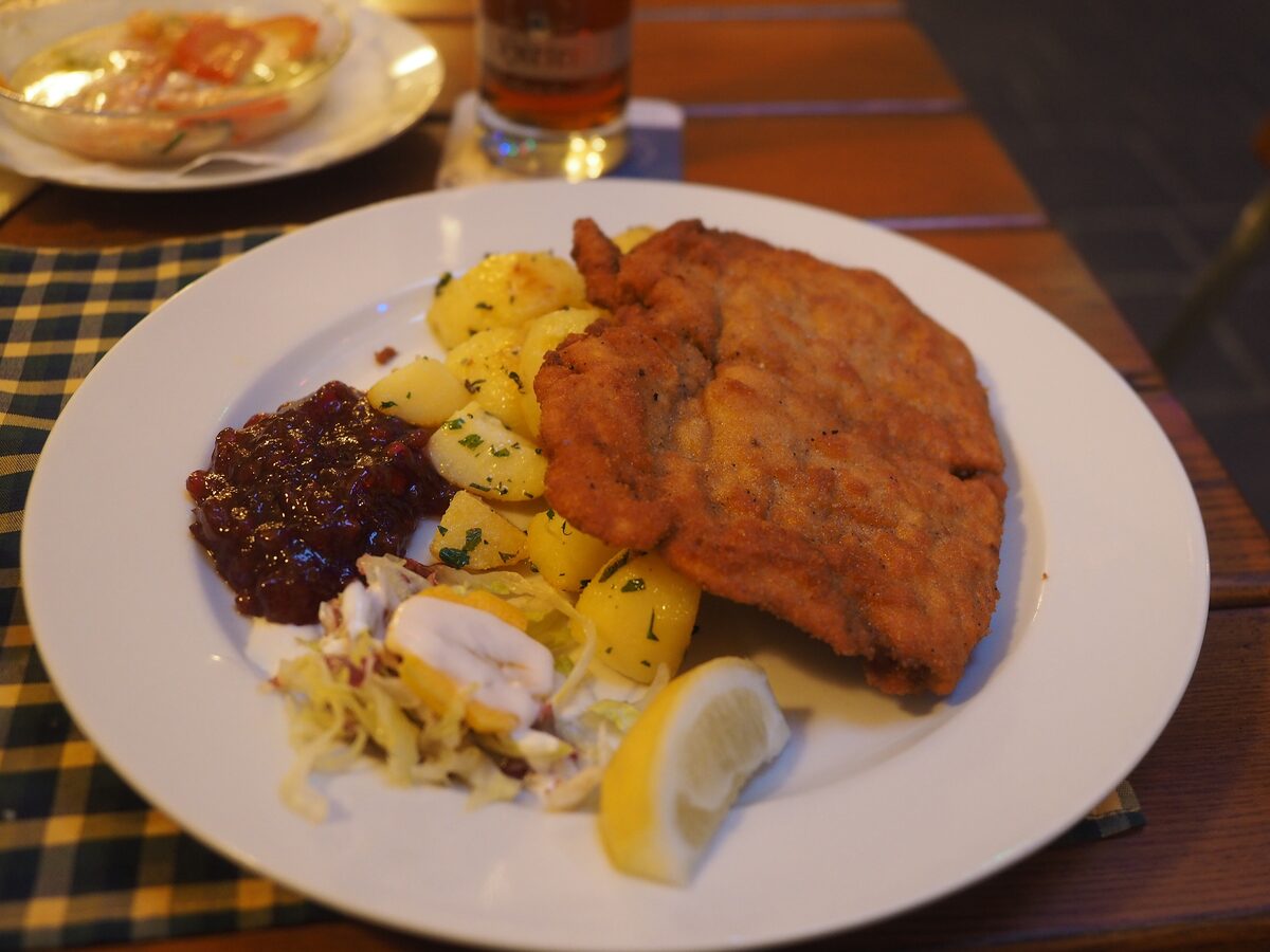 Wiener Schnitzel with parsley potatoes, cabbage salad and a lemon wedge
