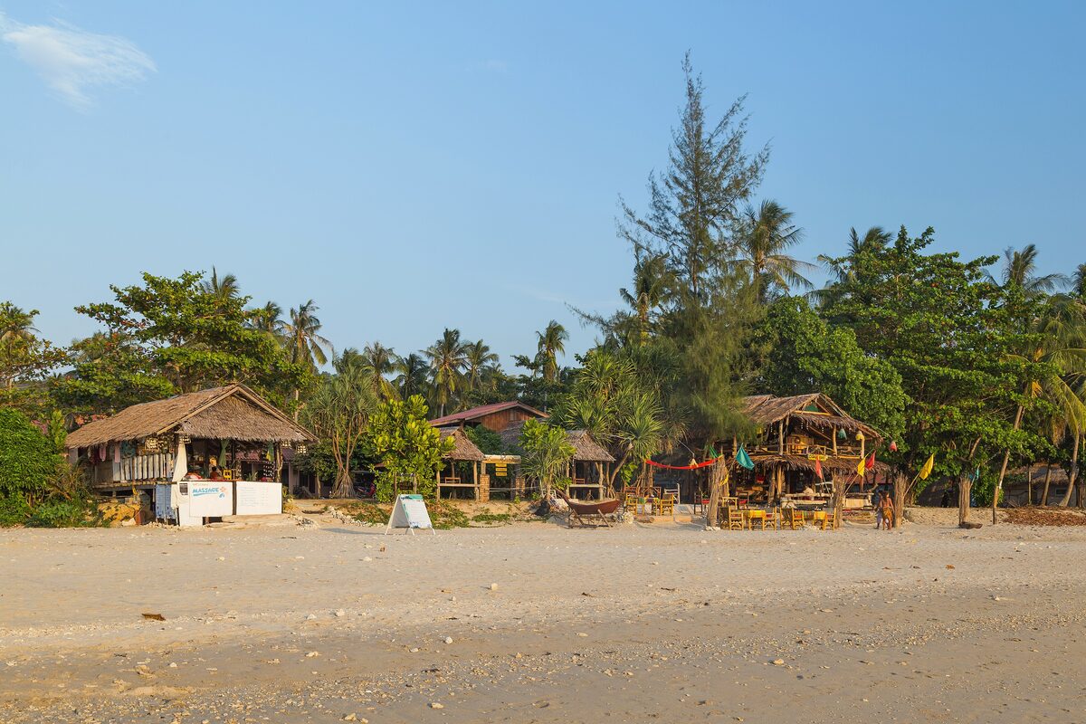 Beach bungalows in the shade of casuarina trees on the sand at Klong Khong, Ko Lanta