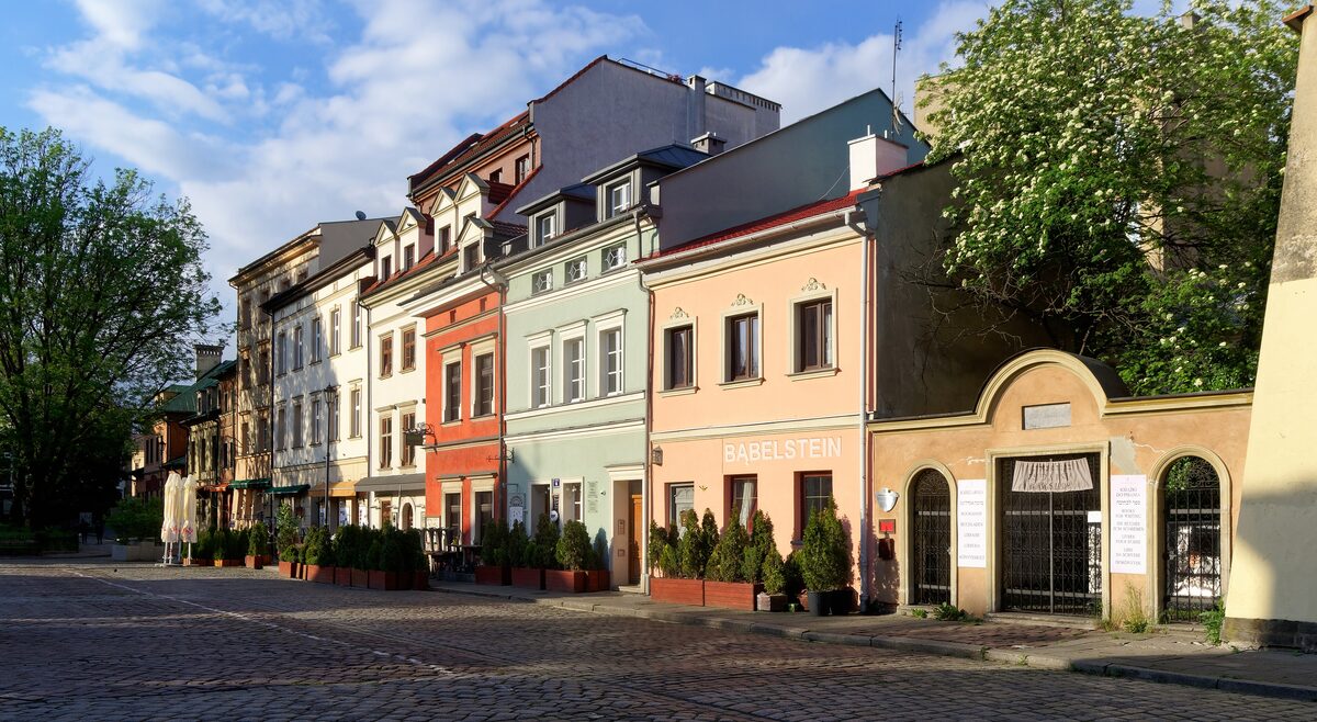A row of colorful old houses and a cobbled square on Szeroka Street in Kazimierz