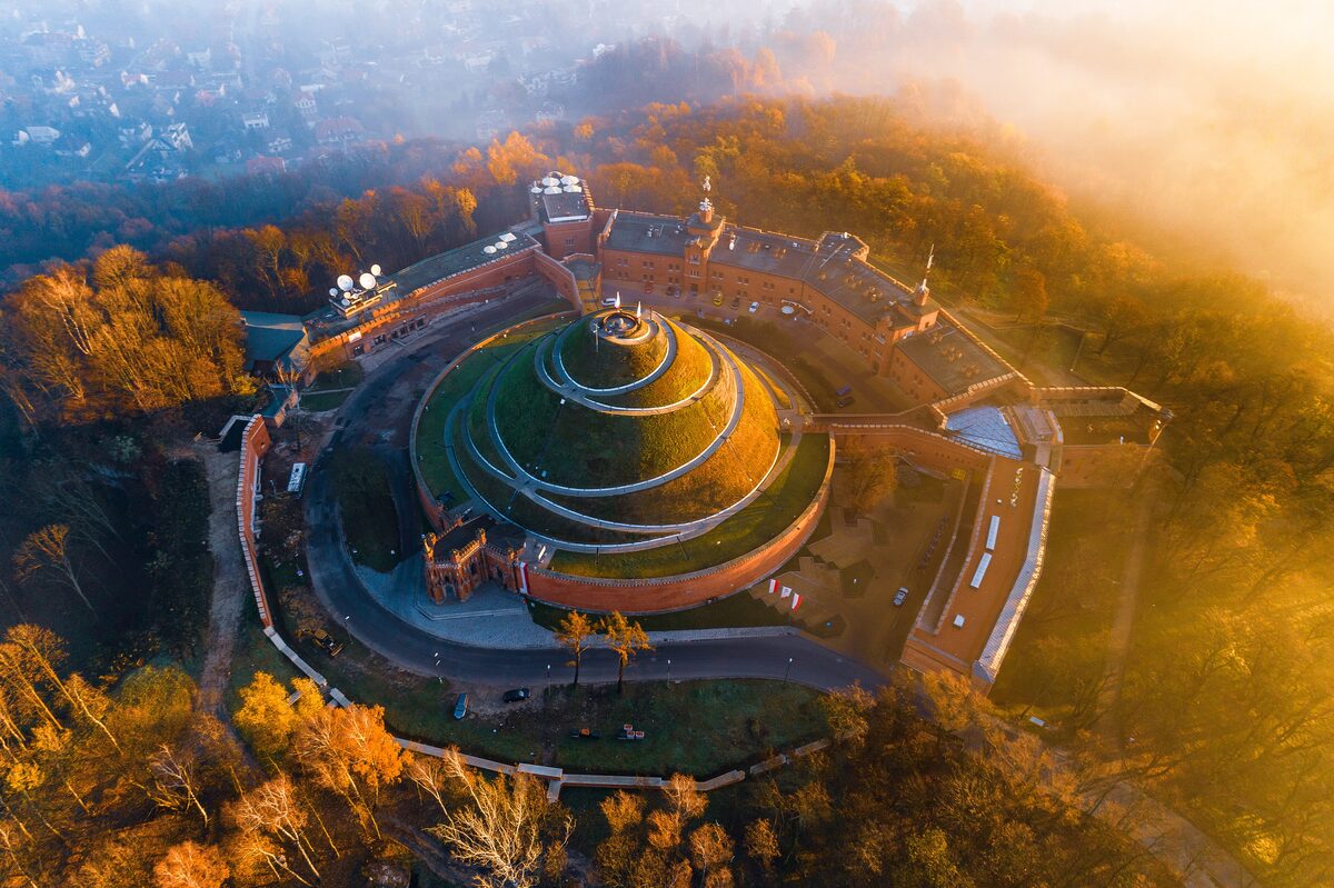Kościuszko Mound and the brick fort around it seen from above in autumn light, with a spiral path to the top
