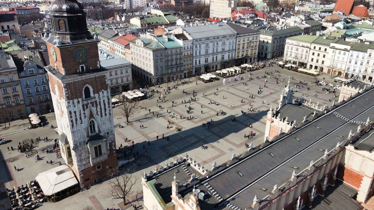 Kraków's Main Market Square seen from above, with the Town Hall Tower on the left and the roof of the Cloth Hall on the right