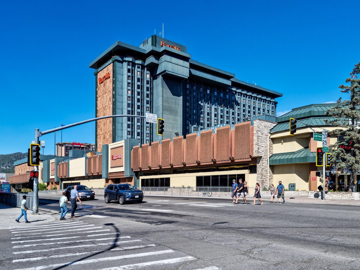 The Harrah's casino tower at the Stateline crossing on US-50 on a summer day, with pedestrians on the crosswalk