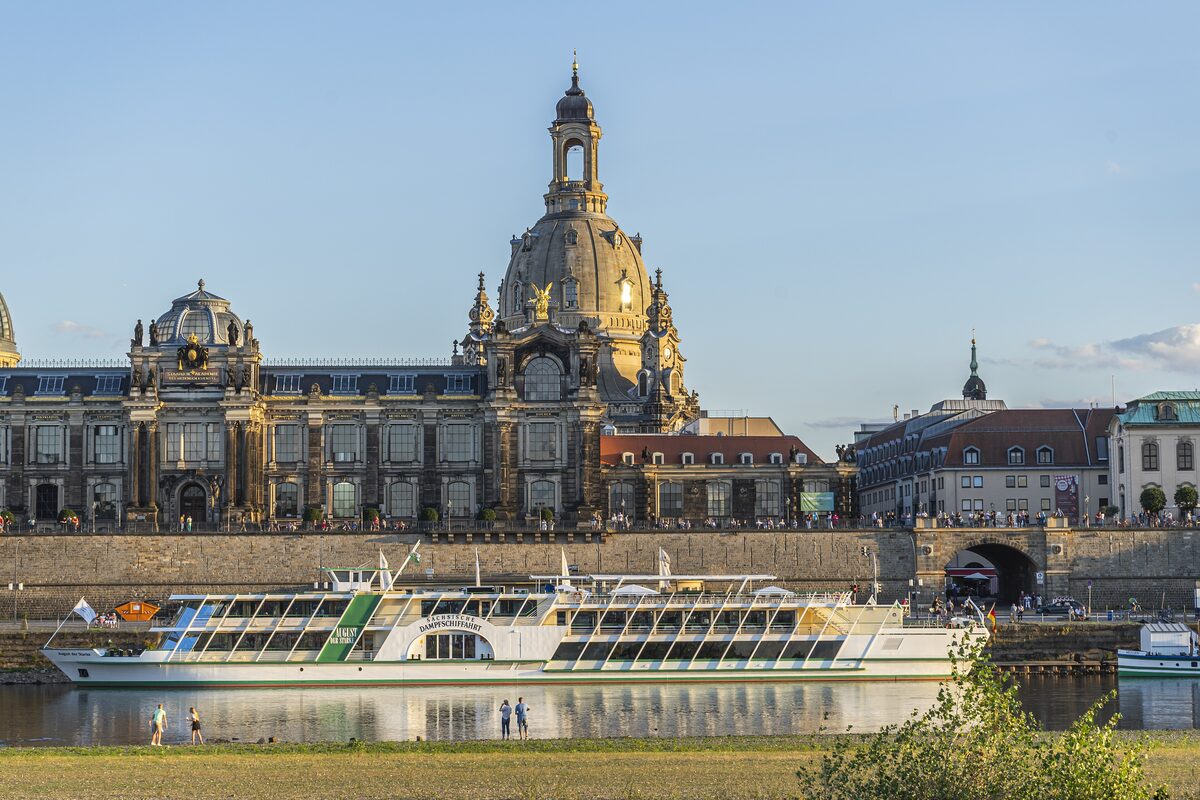 The dome of the Frauenkirche and the Elbe terraces across the river in Dresden, with a paddle steamer at the bank