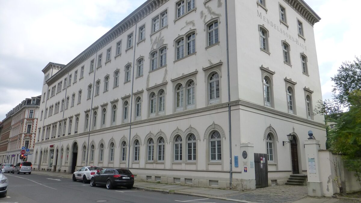 The long, pale facade of the Mendelssohn-Haus with its rows of arched ground-floor windows